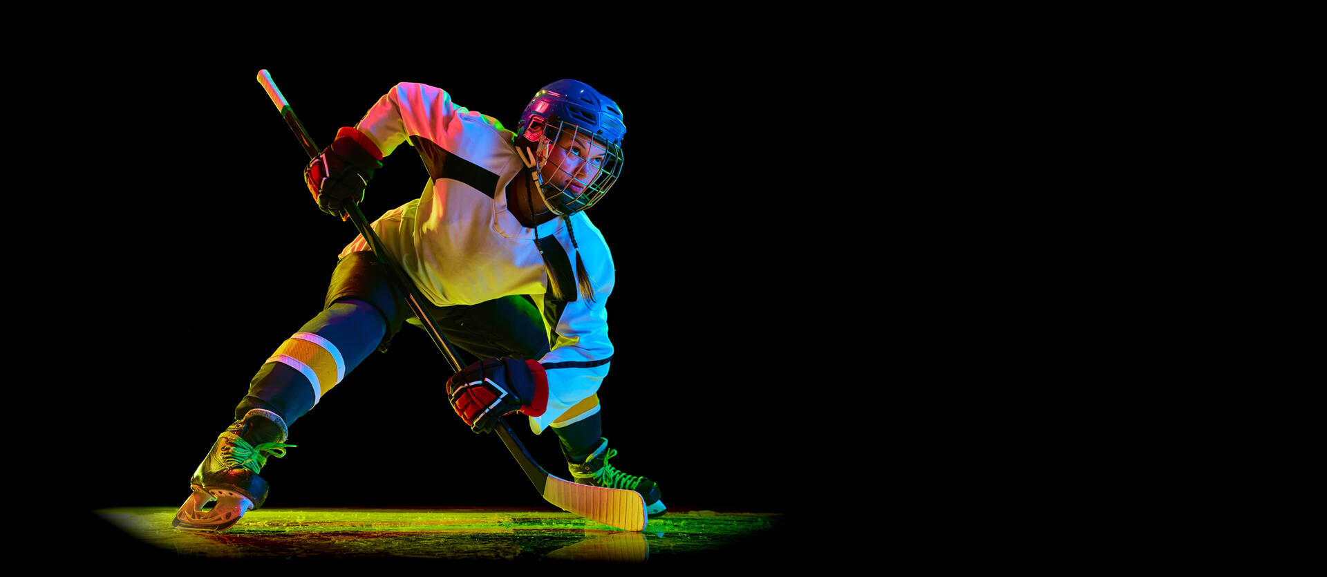 colourfully lit female hockey player